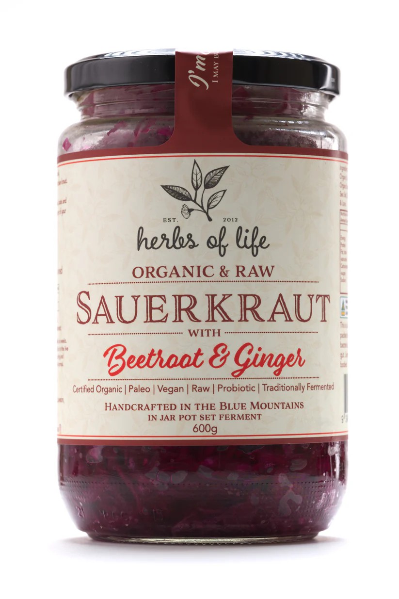 Jar of Herbs of Life Green Cabbage Sauerkraut with Beetroot and Gingeron a white background